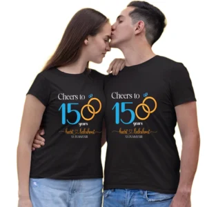 Couple in matching black t-shirts celebrating 15 years, featuring "Cheers to 15 years" design with interlocking rings and personalized names (Hari & Lakshmi) and Roman numerals.