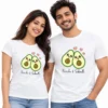 Smiling Indian couple wearing matching white T-shirts with two cute cartoon avocados, pink hearts, and personalized Prachi and Subodh names.
