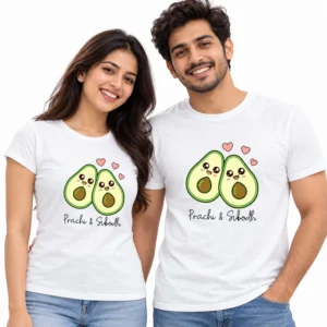 Smiling Indian couple wearing matching white T-shirts with two cute cartoon avocados, pink hearts, and personalized Prachi and Subodh names.