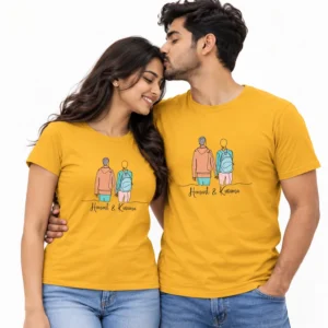 Indian couple wearing matching mustard yellow T-shirts with a colorful illustration of two people walking hand in hand and Hemant and Kusuma names.