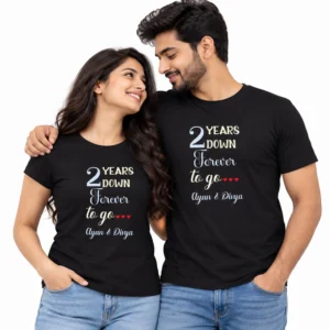 Couple wearing matching black anniversary T-shirts with 2 Years Down Forever to Go lettering, red hearts, and personalized Ayan & Divya names.