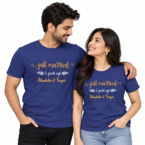 Husband and wife wearing matching blue Just Married 5 Years Ago anniversary T-shirts with gold lettering, white leaf decorations, and Akanksha & Sagar names.