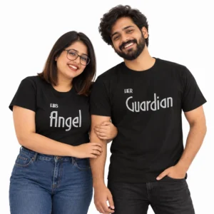 Indian couple wearing matching black T-shirts with white outlined typography, featuring His Angel on the women's T-shirt and Her Guardian on the men's T-shirt against a clean white background.