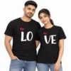 Indian couple wearing matching black LO and VE T-shirts with large white lettering and small red heart designs.