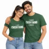 Indian couple wearing matching green T-shirts with I Am Everything and I Have Everything I Need white typography designs.