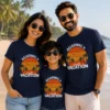 Family wearing personalized navy blue Agarwal's Family Vacation T-shirts with tropical sunset and palm tree design