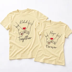 Two pale yellow personalized couple T-shirts laid flat with Rahul and Priya names, red heart graphics, hand line art, and Together Forever text.