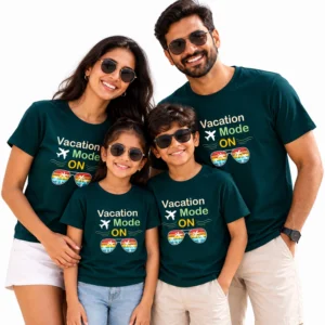 Family of four wearing matching dark teal personalized family vacation T-shirts with colorful “Vacation Mode ON” airplane and sunglasses print.
