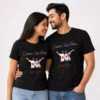 Couple wearing black personalized T-shirts with custom name text, cartoon couple illustration, and romantic “loves you” design.