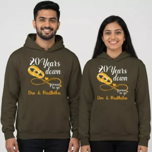 Personalized 20th anniversary couple hoodies with “20 years down, forever to go” design worn by a smiling couple