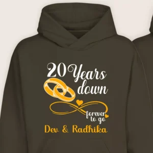 Close-up of personalized 20th anniversary hoodie with gold rings and custom names Dev and Radhika