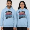 Couple wearing matching light blue 25th anniversary couple hoodies with infinity heart design and “25 Years Together” print.