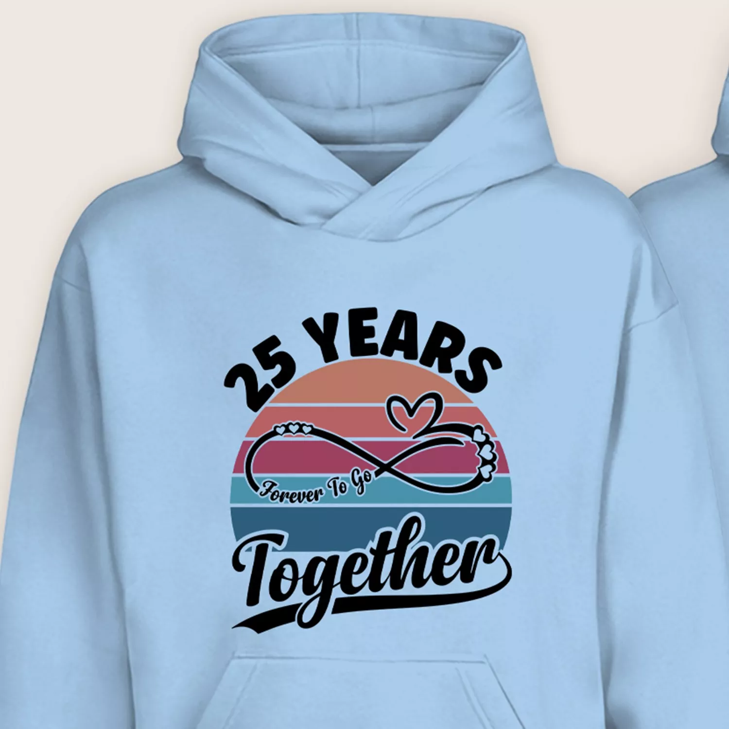 Close-up of light blue 25th anniversary hoodie with infinity heart graphic and “25 Years Together” design.
