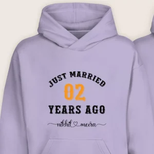 Close-up of lavender 2nd anniversary custom couple hoodie with “Just Married 02 Years Ago” printed design and personalized names.