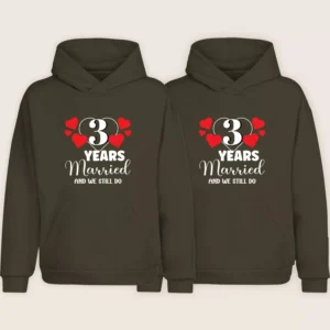 Matching 3rd anniversary couple hoodies in brown with “3 Years Married and We Still Do” printed design
