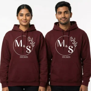 Couple wearing maroon personalized initials matching couple hoodies with M & S initials and EST.2025 print