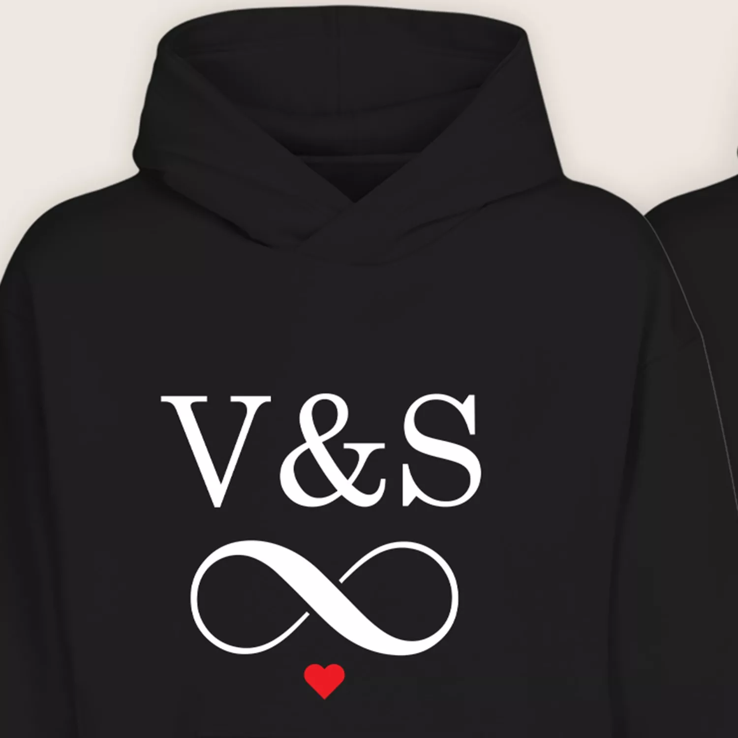 Close-up view of personalized couple hoodie with custom initials and infinity heart design in white and red