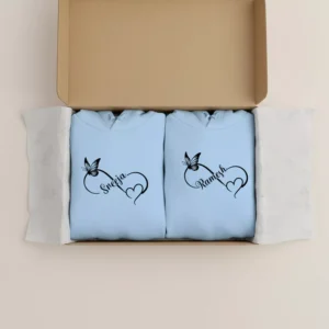 Personalized couple hoodies with custom names packed neatly in a gift box with butterfly heart design