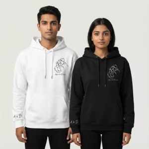 Couple wearing matching line art hoodies with custom names and sleeve initials in white and black colors