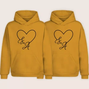 Matching yellow couple hoodies with custom initials and heart design printed on the front
