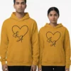 Matching custom initials printed couple hoodies with heart design in mustard yellow color
