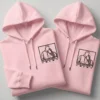 Pink couple hoodies with custom line-art portrait embroidery and matching minimalist design.