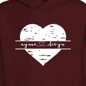Close-up of custom name couple hoodie with white heart design and personalized names on maroon sweatshirt.