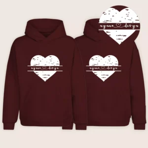 Pair of maroon custom name couple hoodies with white heart design and personalized names displayed together.