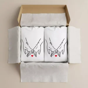 Custom name initial couple hoodies packed in a gift box with matching hand-holding design