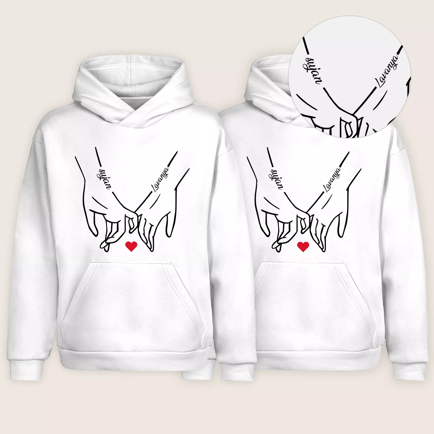White custom name initial couple hoodies with matching hand-holding line-art design and red heart
