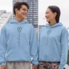 Couple wearing light blue Custom Printed Name Couple Hoodies with heart design – personalized romantic matching pair