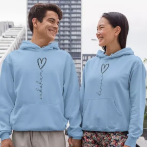 Couple wearing light blue Custom Printed Name Couple Hoodies with heart design – personalized romantic matching pair