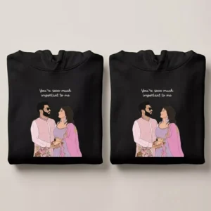 Folded black anniversary couple hoodies with custom vector portrait illustration and personalized quote