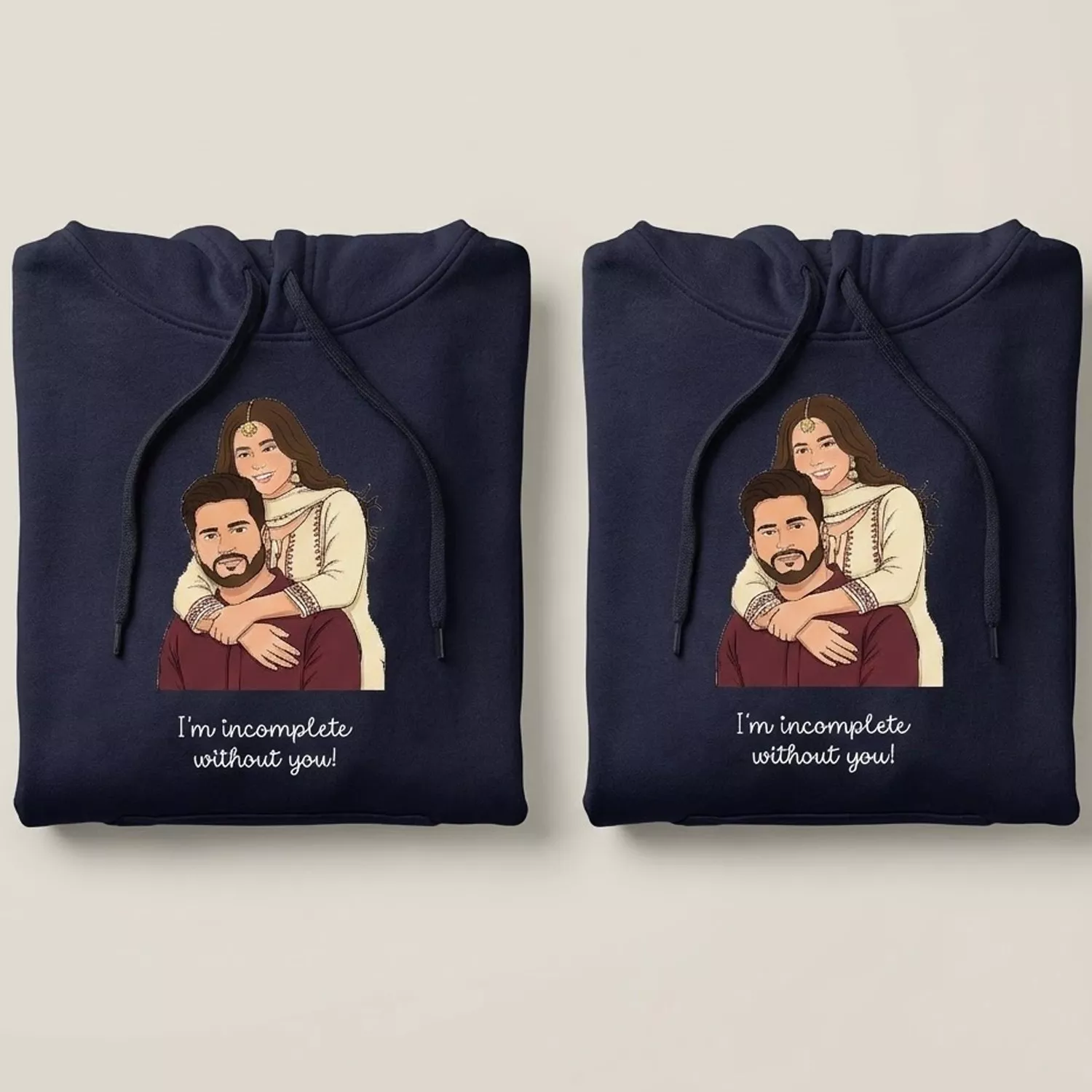 Folded personalized anniversary couple hoodies with custom vector cartoon artwork in navy blue