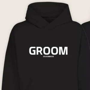 Close-up of black Groom hoodie with bold white text and custom wedding date printed on the front.