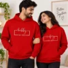 Matching red couple hoodies with Hubby and Wifey EST 2025 print worn by a man and woman
