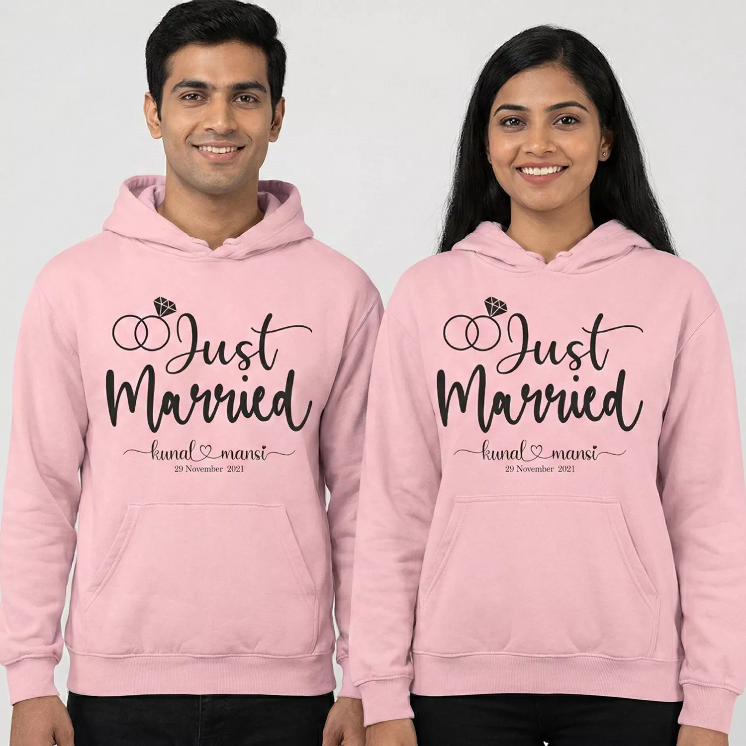 Pink “Just Married” personalized 8th anniversary couple hoodies with custom names and date worn by a smiling man and woman.