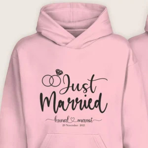 Close-up of a pink “Just Married” personalized hoodie with custom names and date printed on the front.