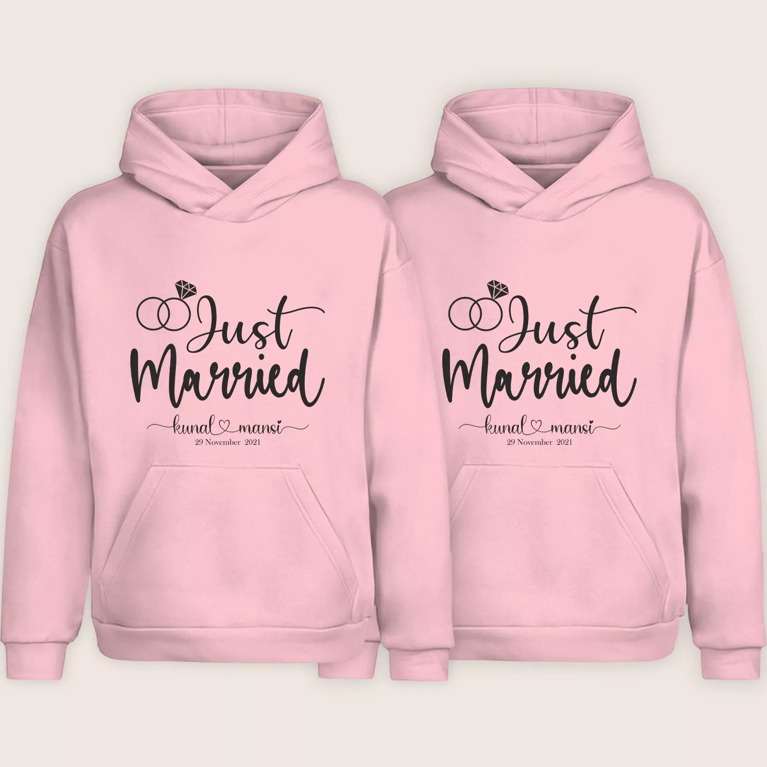 Two pink “Just Married” personalized couple hoodies with custom names and date displayed on a plain background.