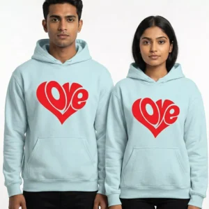 Couple wearing light blue hoodies with red love heart typography design
