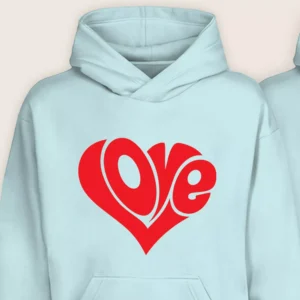 Close-up view of the Love Heart typography print on a light blue matching couple hoodie