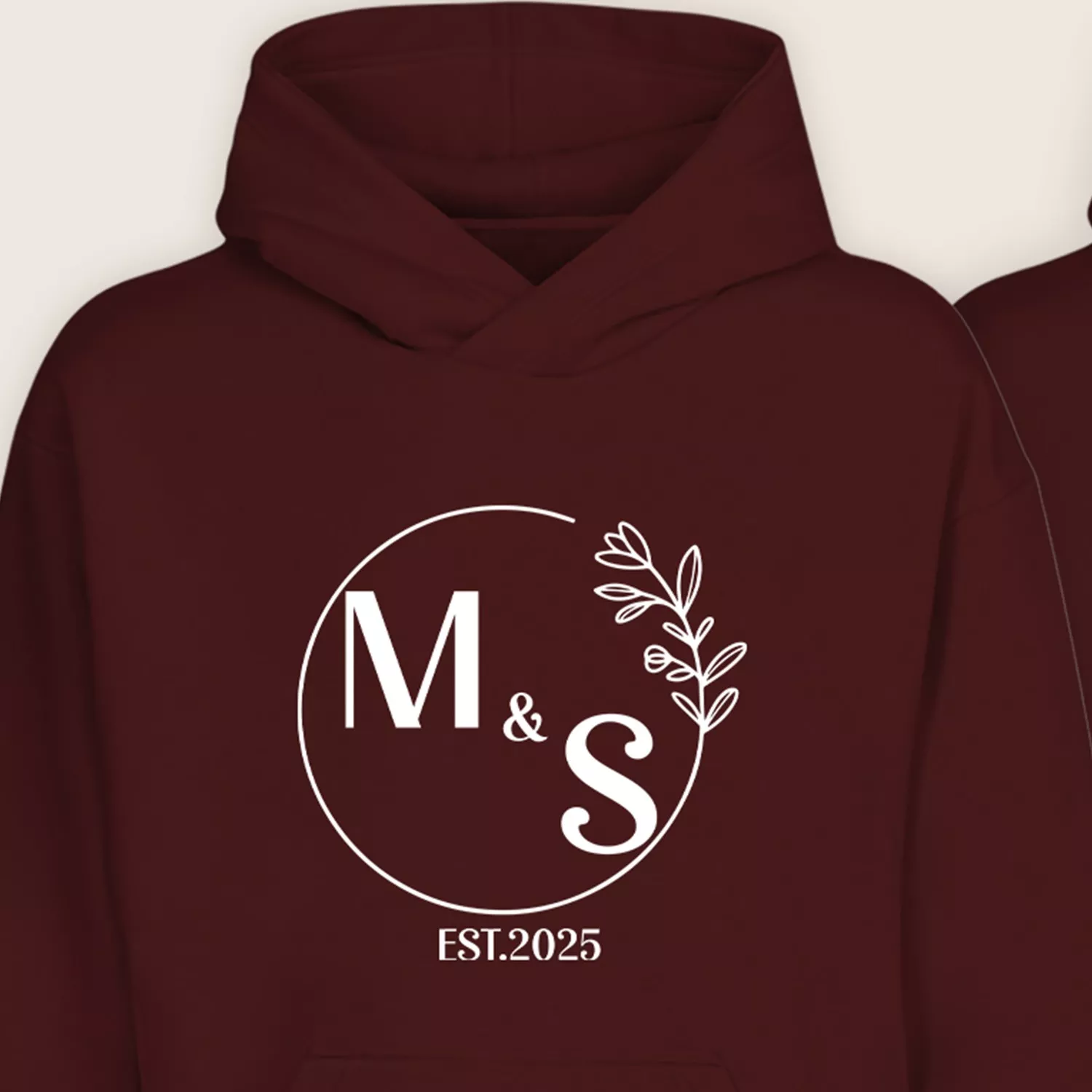 Close-up of maroon couple hoodie with personalized M & S initials and EST.2025 print