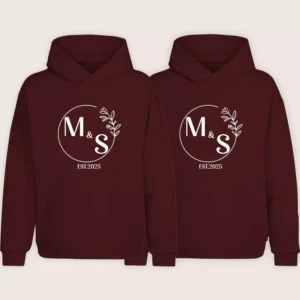 Maroon matching couple hoodies with personalized M & S initials and EST.2025 design