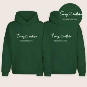 Green matching couple name hoodies with personalized names and date printed in white on the front.