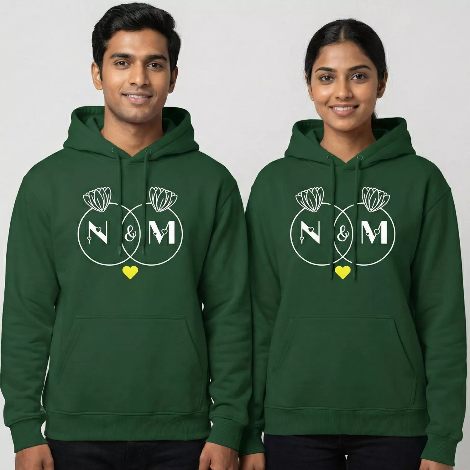 Couple wearing matching green Initial Letter Personalized Couple Hoodies with custom initial letters and lotus design