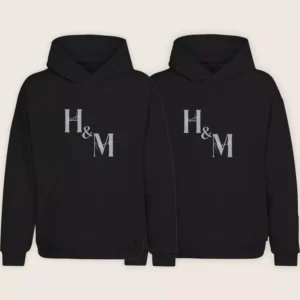 Matching personalized couple hoodies with custom initials H and M printed on black hoodie set