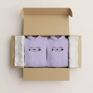 Folded minimal name printed couple hoodies in lavender packed inside a gift box – personalized matching hoodies for couples with name and year design.
