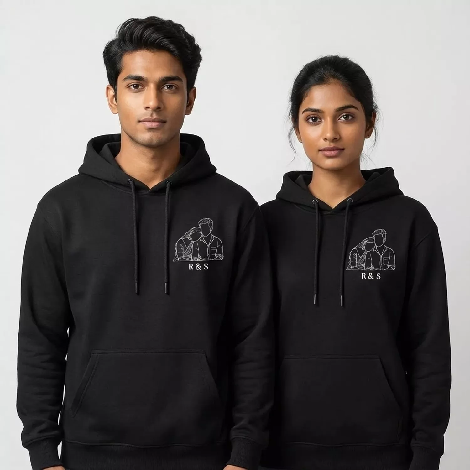 Couple wearing black minimal photo outline embroidery hoodies with personalized initials