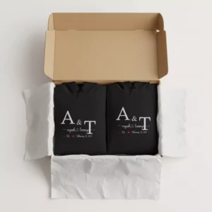 Personalized couple hoodies with custom initials and names neatly packed in a gift box