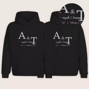 Matching black couple hoodies with personalized initials, names, and anniversary date printed on the front